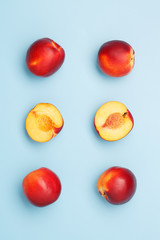 A few ripe nectarines on a blue background