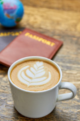 White cup with latte. Coffee foam flower picture.