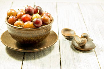 Berries in rural dishes. Berries on a white background.