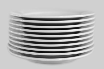 Stack of clean white plates on an isolated background. Cutlery for eating.