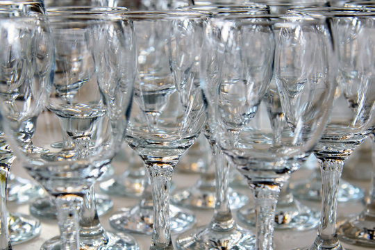 Empty glasses for wine on the holiday table ready to spill alcohol. Serving a formal dining event. Cutlery for people in the restaurant.