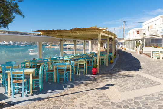 Chairs with tables in typical Greek tavern in Pollonia village on Milos Island. Greece.