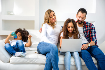 Young family sitting on the couch