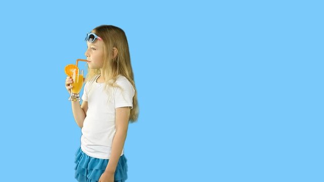 A young girl walks by drinking juice and waving her hand. Clip with transparent Alpha Channel.