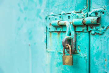 close up to the key  unlock with vintage green door, abstract background with vintage filter. to show the old texture on metallic.