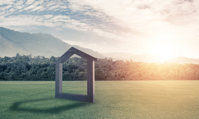 Conceptual background image of concrete home sign on green grass
