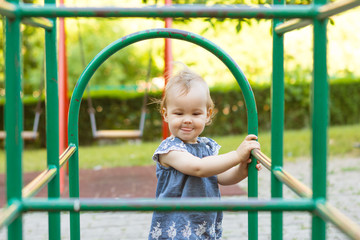 Baby girl playing on the children's playground