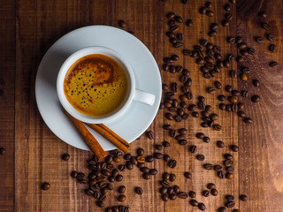Coffee cup and coffee beans on table