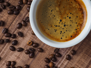 Coffee cup and coffee beans on table