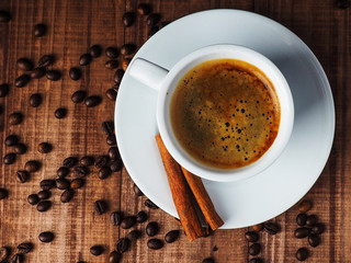 Coffee cup and coffee beans on table