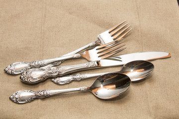 Silver flatware set serving utensils, ornate spoons, forks, knife