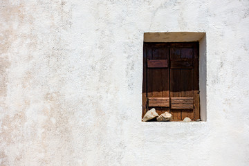 Wooden window on old white wall
