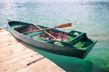 green boat on the pier