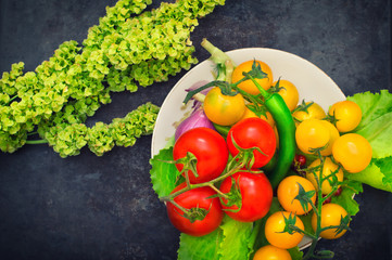 Set organic food. Fresh raw vegetables for salad. On a old blue background. Top view. Close-up