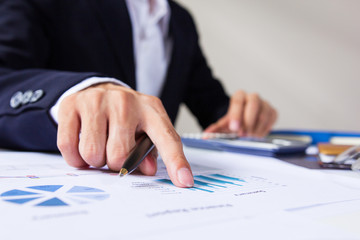 Businessman check seriously analyzes a finance report investor colleagues discussing new plan financial graph data. Finance managers task. Concept business and finance ,Account analyzes planing