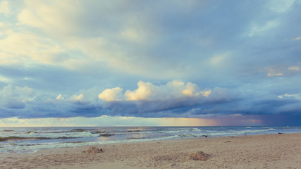 Fototapeta na wymiar Beatiful sunset with clouds over sea and beach
