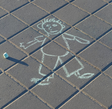 Funny drawing of a man by chalk on the asphalt
