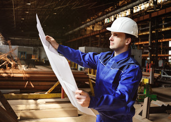 Portrait of an engineer holding a blueprint