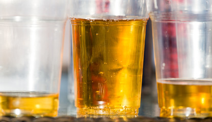 Beer in a plastic glass on the table