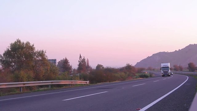 Sunset highway with vehicles