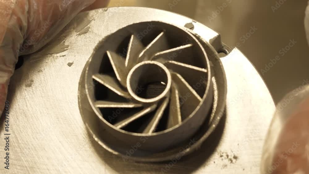 Poster 3d printed iron product. young designer engineer using a 3d printer in the laboratory and studying a