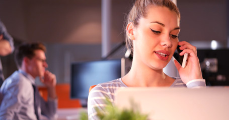 woman using mobile phone in dark office