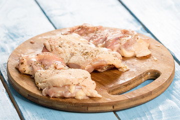 Raw chicken drumsticks prepared with spices for barbecue