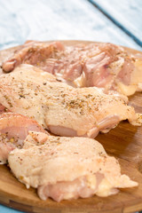 Raw chicken drumsticks prepared with spices for barbecue