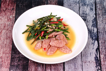 Fried Chinese chives with Thai sour sausage .