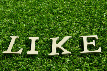 Like wording placed on artificial green grass background