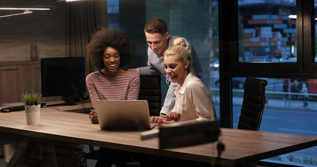 Multiethnic startup business team in night office