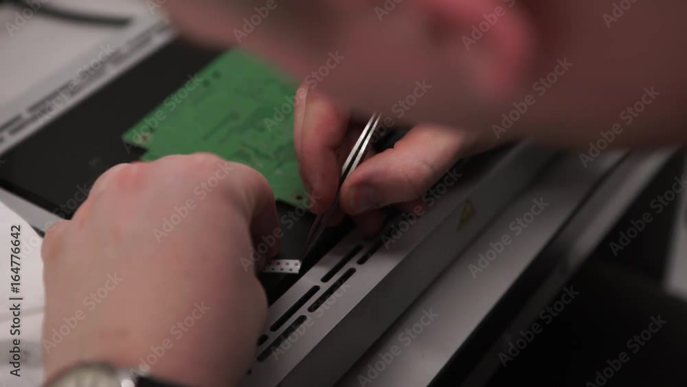 Poster hand with tool repairing cell phone and other gadgets. microchip production factory. technological p