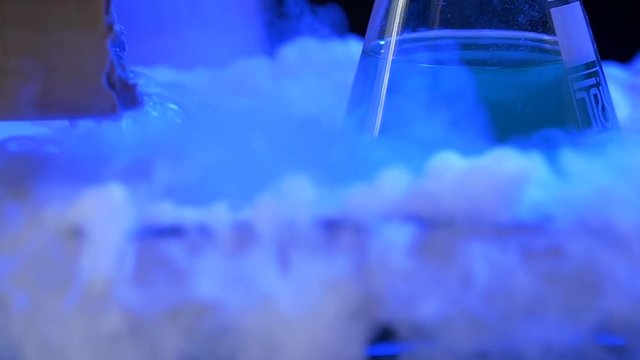 Chef is cooking ice cream with liquid nitrogen. A stainless steel dewar flask with liquid nitrogen. liquid nitrogen, flask