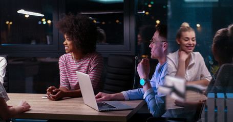 Multiethnic startup business team in night office