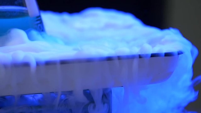 Chef is cooking ice cream with liquid nitrogen. A stainless steel dewar flask with liquid nitrogen. liquid nitrogen, flask