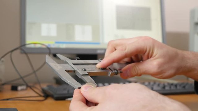 Man using vernier caliper. Man uses steelconsult to measure