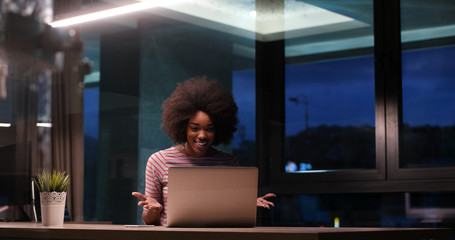 Fototapeta na wymiar black businesswoman using a laptop in night startup office