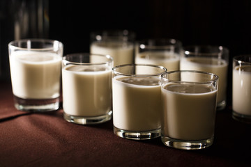 A glass of buttermilk on the brown tablecloth