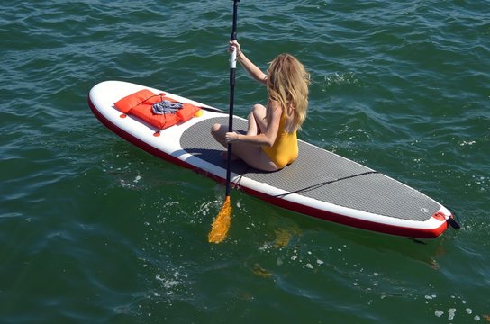 Attractive Lady On A Paddle Board In The Florida Intra-coastal Waterway Off Miami Beach.