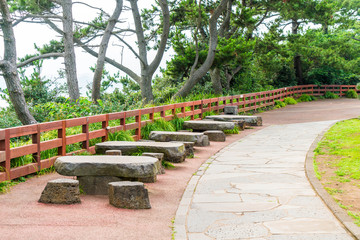 empty bench in park atJungmun Daepo Coast Jusangjeolli Cliff, Jeju Island