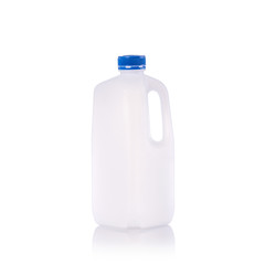 Clear blank empty milk bottle with blue cap. Studio shot isolated on white