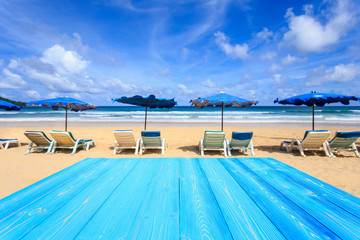 Top blue wooden table and view of tropical beach background. For display or product montage design