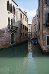 Fototapeta na wymiar Beautiful building along the canal with tourist walking around in Venice
