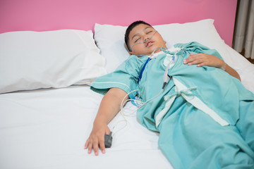 Asian boy wearing Sleep Apnea Diagnostic medical device Kit. Sleep Lab Test.