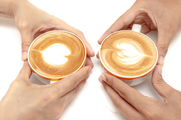 Coffee cups of latte art heart shape, drinking together, on white background isolated