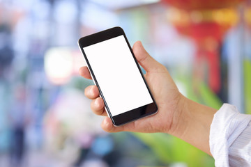 Man using smartphone at abstract blurred street night. Blank screen for graphics display montage.
