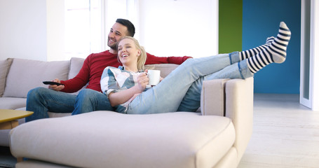 Young couple on the sofa watching television