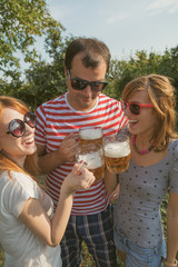 Several friends enjoying outdoors with the beer.