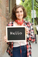 Woman holding chalkboard with text "friends". © Mego-studio