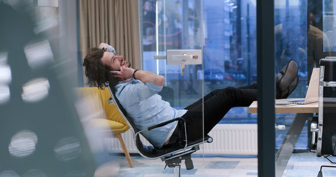 businessman sitting with legs on desk